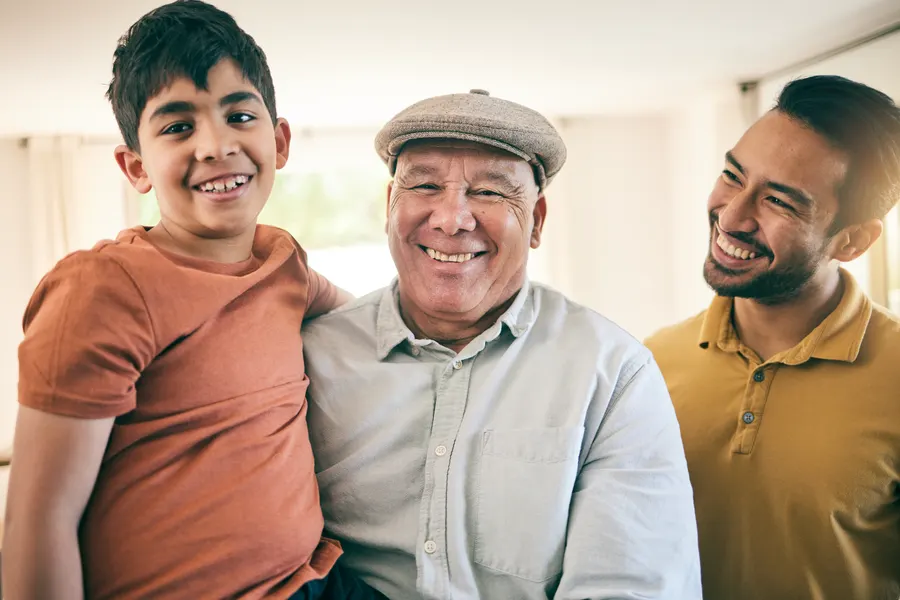 Niño, padre y abuelo sonriendo (imagen referencial)